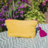 Pochette en tissu éponge avec doublure wax du Sénégal et pompon en laine du Maroc